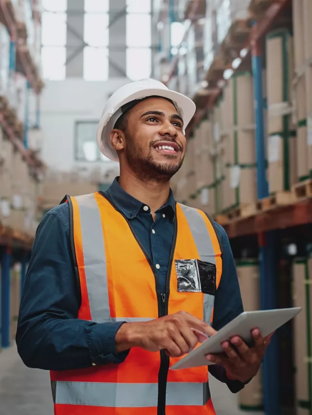 man in warehouse holding tablet