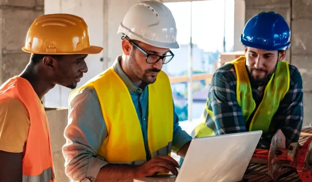 construction team using laptop