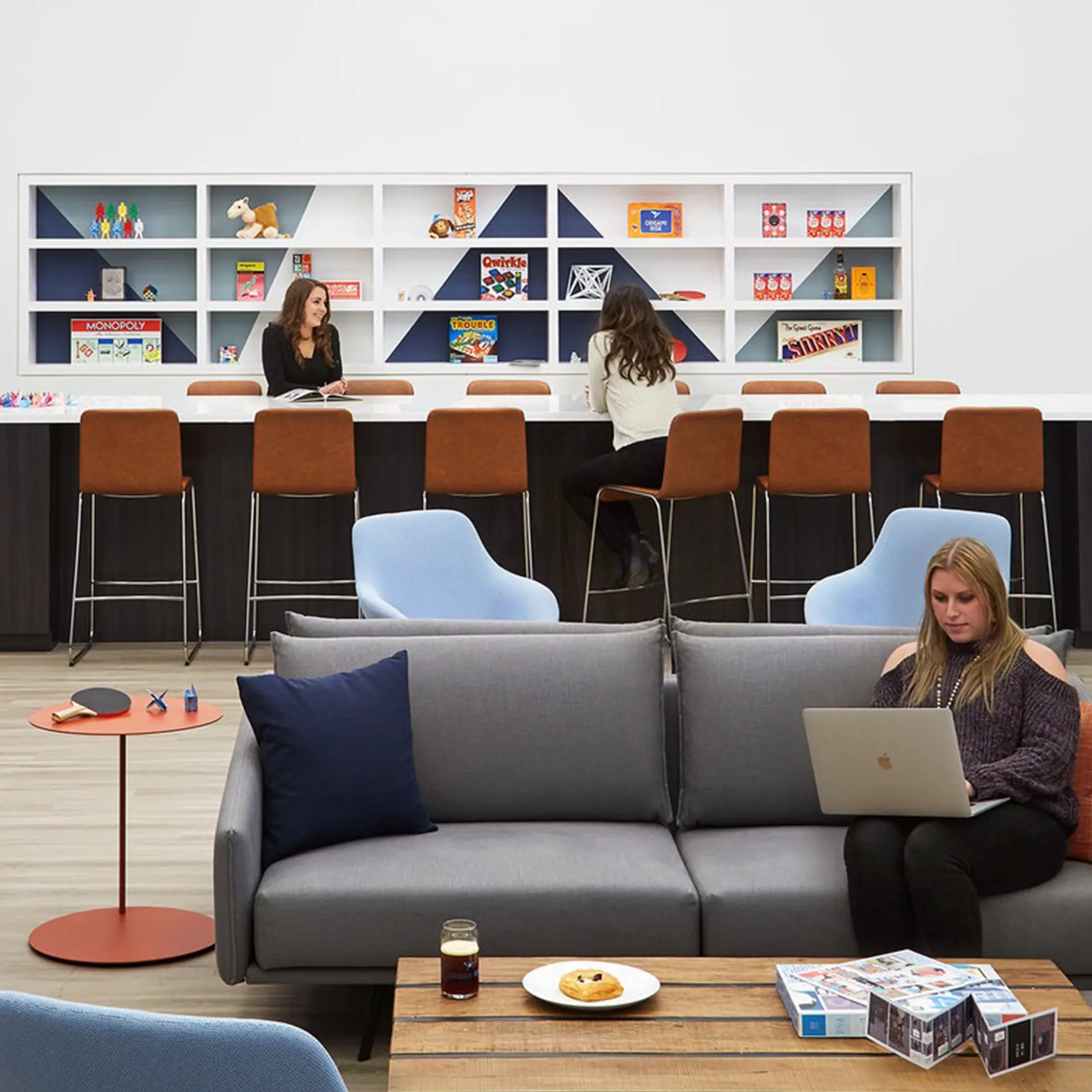 Employees relaxing inside a break room.
