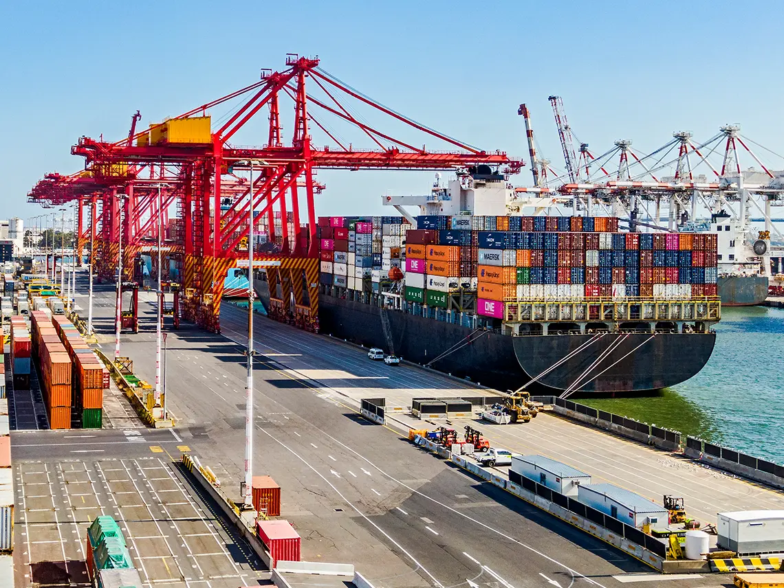 A cargo ship docked at a port.