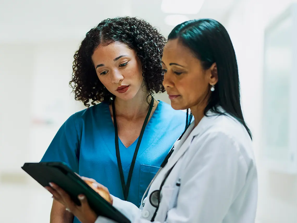 A doctor consulting with a nurse.