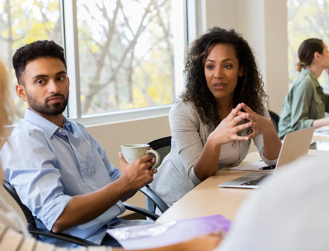 A group of professionals in a meeting room.