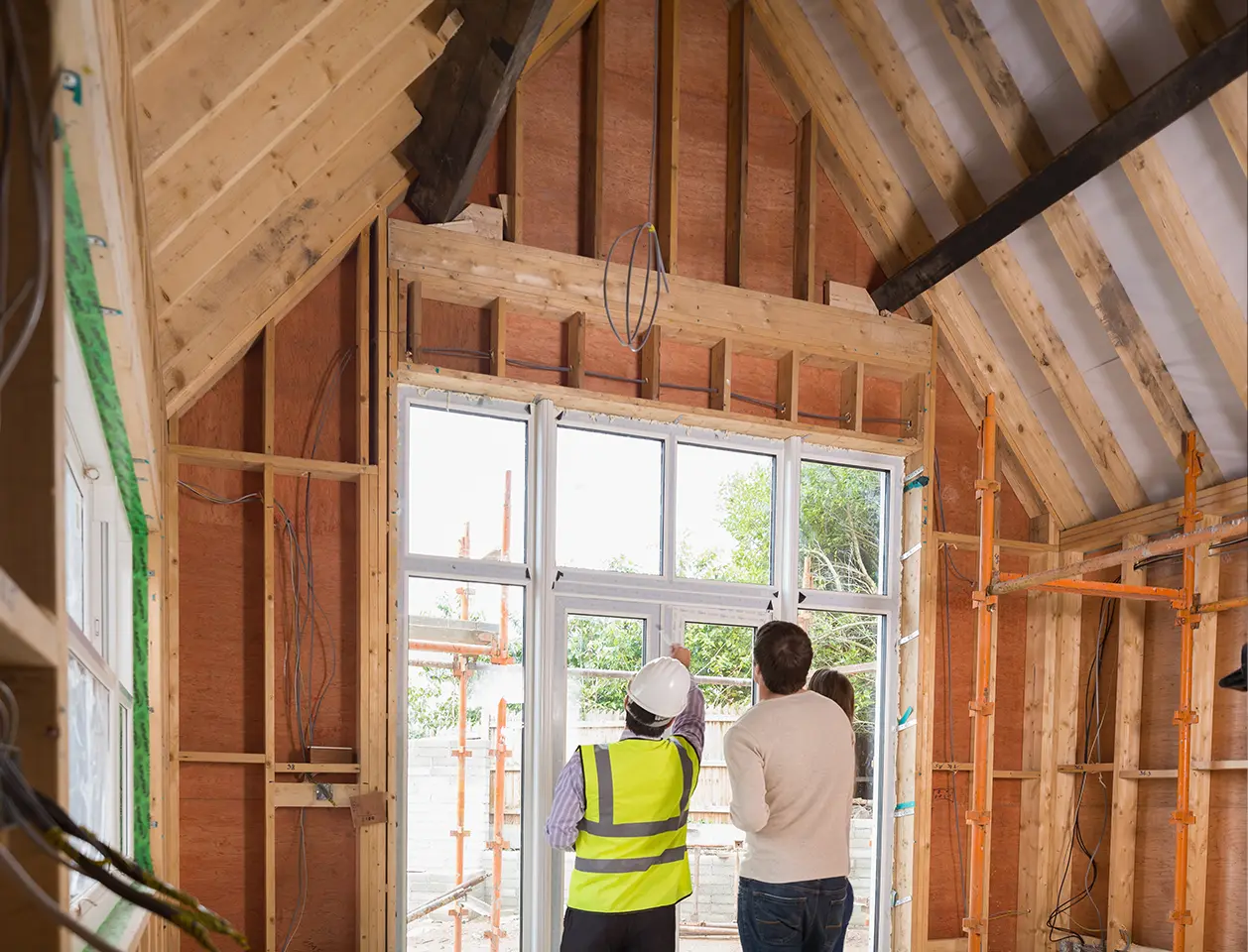 Door inspector discussing with clients over a door frame.