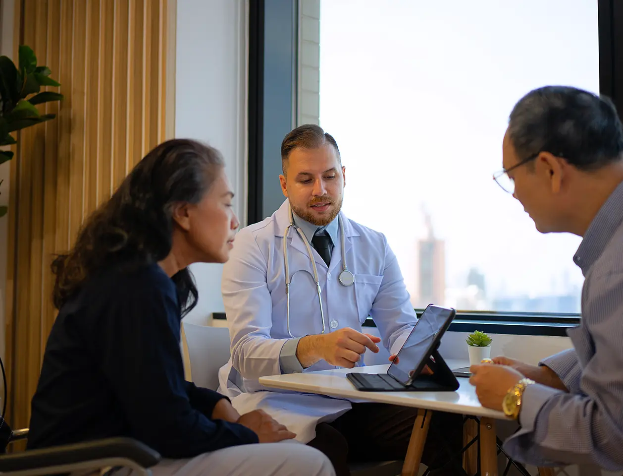 A doctor consulting two patients.