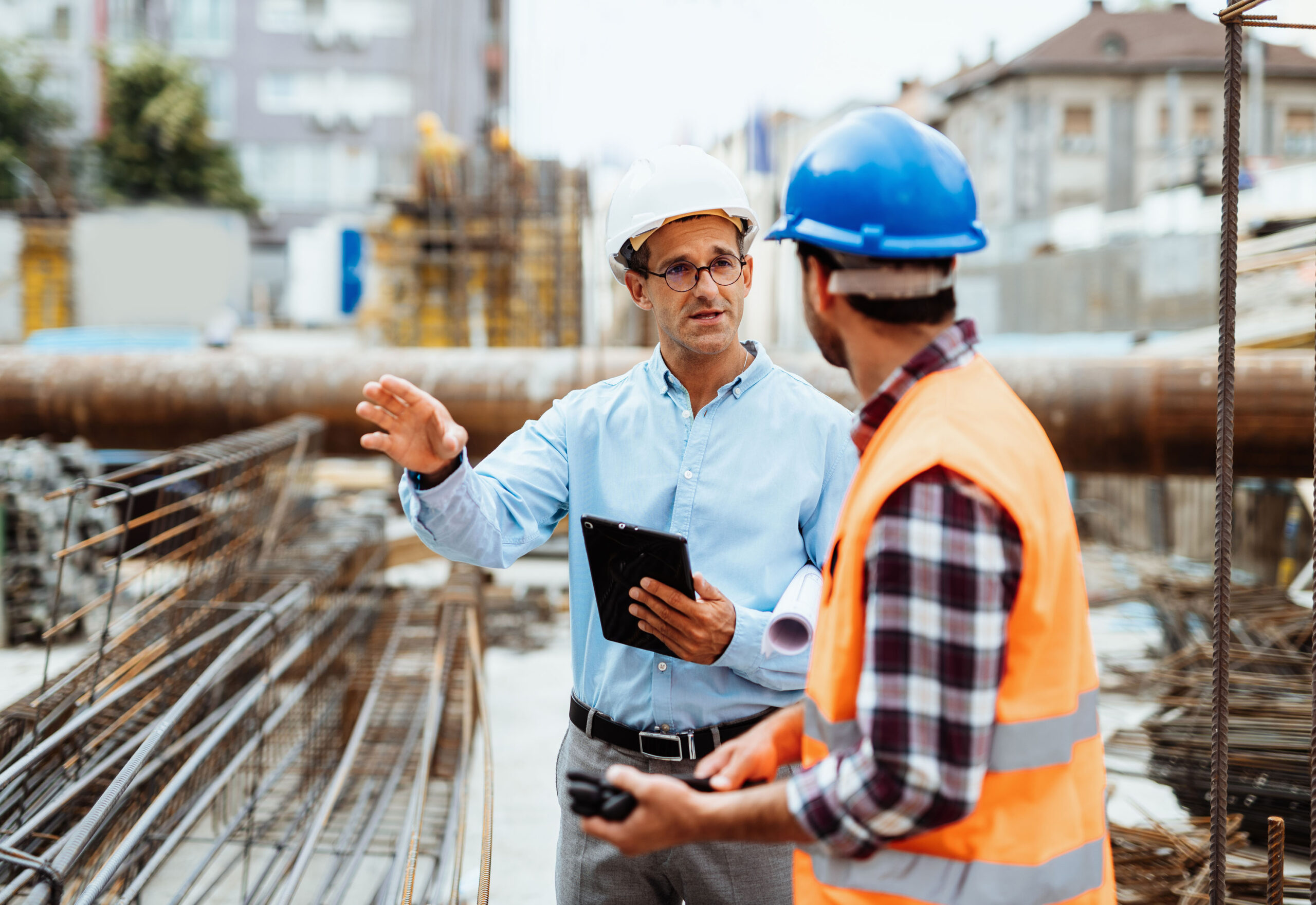Engineers with digital tablet on the construction site