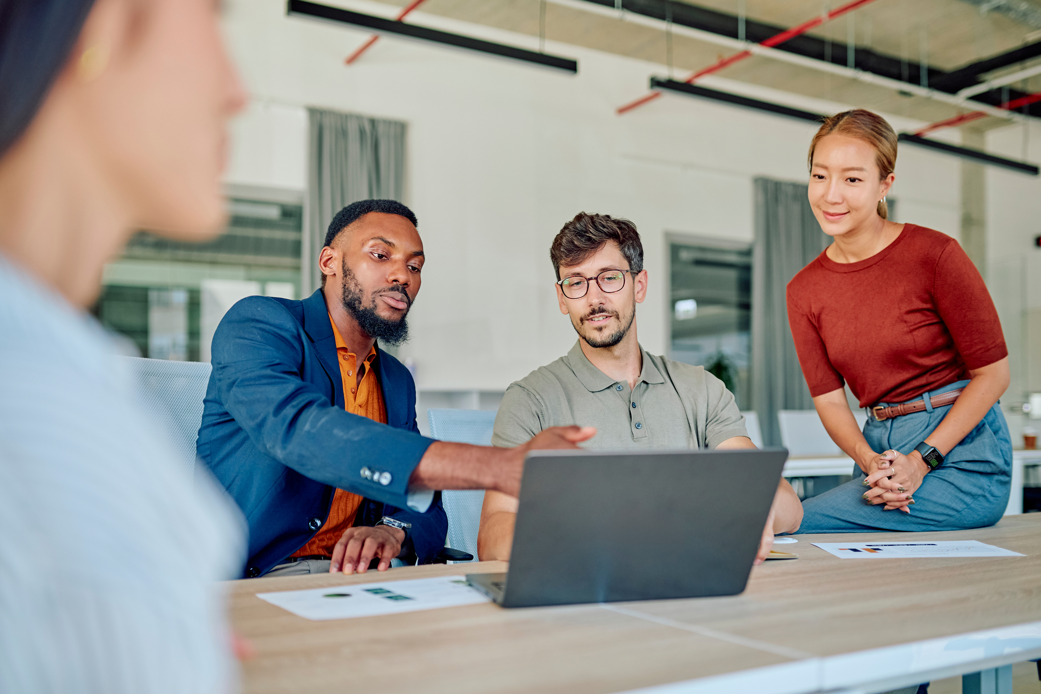 Marketing team discussing strategy during meeting in modern office