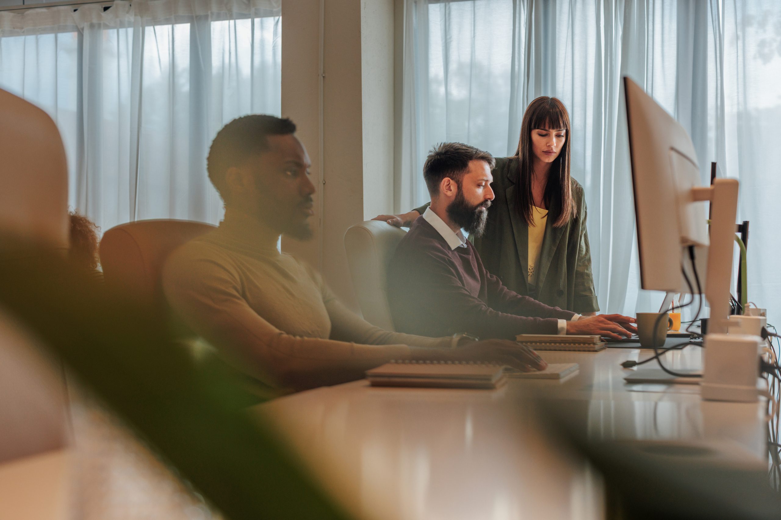 Business team working together on a computer in the office